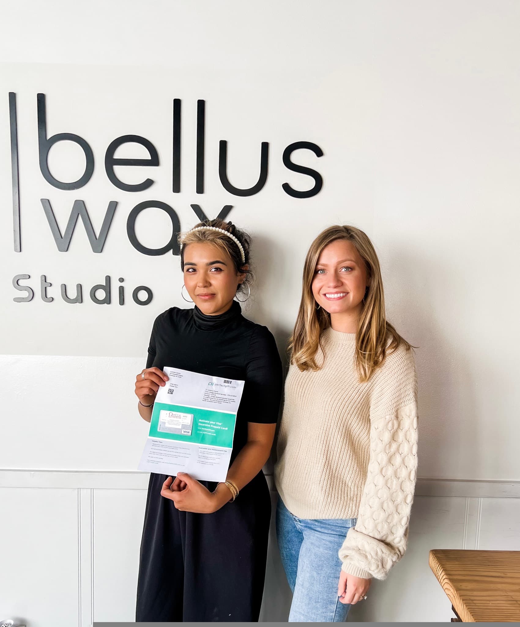 Merchant partners with Omega rewards program materials and prepaid incentive card at their business