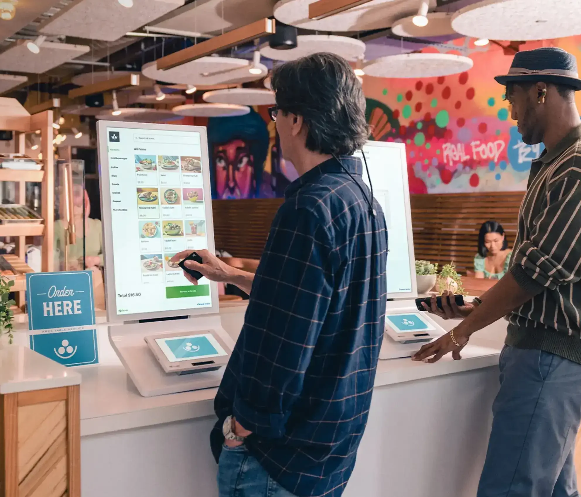 Clover ordering kiosk device installed in a quick-service environment