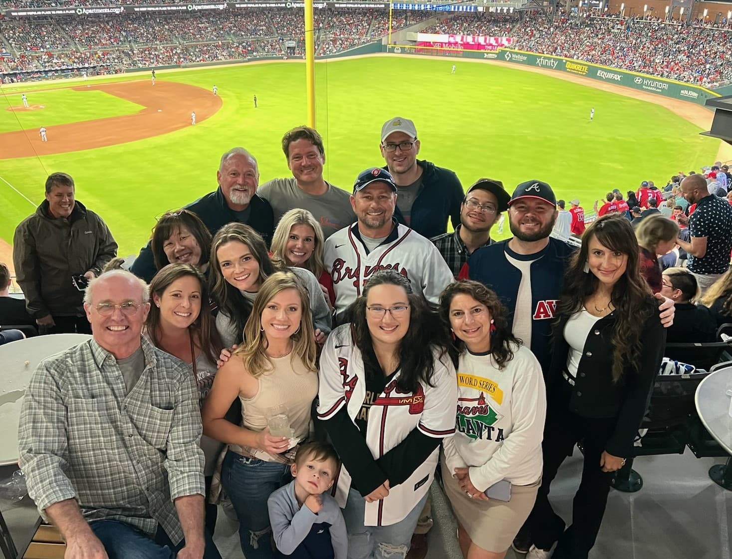 Omega Bank Card Services team group photo at Truist Park during an Atlanta Braves game, company outing